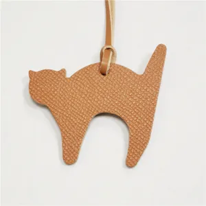 Cute leather cat bag charm pendant for women handbag decoration, stylish accessory item.