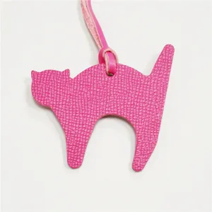 Pink leather cat bag charm detail, cute animal pendant accessory for women handbags and purses.