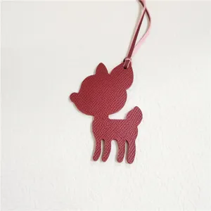 Cute deer leather bag charm, red-brown handbag pendant, stylish purse accessory for women.