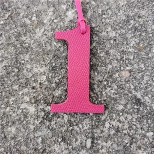 Detailed view of a hot pink leather number 1 bag charm, perfect for personalized DIY accessories.