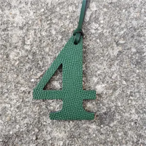 Green leather number 4 bag charm pendant DIY accessory detail shot showcasing texture and design.