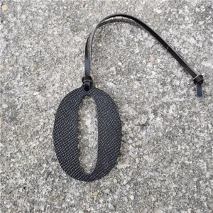 Black leather number 0 bag pendant detail, DIY accessory charm for handbags and purses.