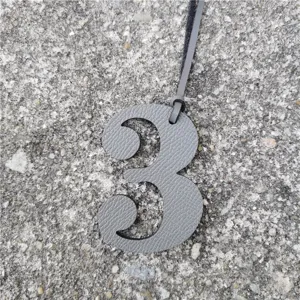 Gray leather number 3 charm detail shot, textured DIY bag pendant accessory close-up display.