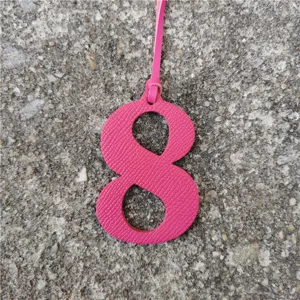 Pink leather number 8 bag charm, textured DIY pendant accessory for stylish handbags.