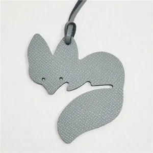 Grey leather fox bag charm detail, stylish animal pendant accessory for handbags and purses.