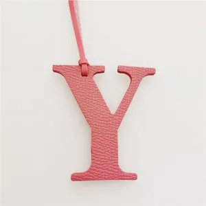 Pink leather letter Y bag charm initial pendant accessory luxury style detail view.