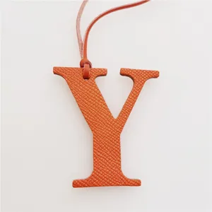 Orange leather letter Y bag charm initial pendant minimalist stylish accessory for handbags.
