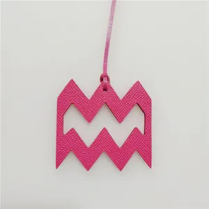 Pink leather Aquarius zodiac symbol hanging charm accessory for bags and keys decoration detail view