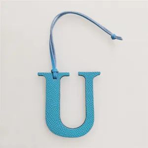 Blue leather letter U bag charm, stylish initial pendant accessory for handbags and purses.