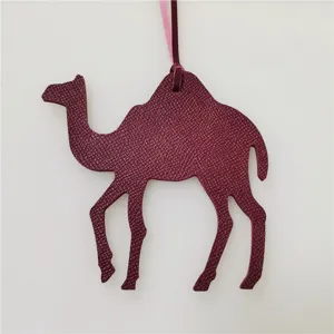 Elegant leather camel bag charm pendant, stylish handbag accessory for women daily use.