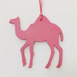 Cute pink leather camel bag charm accessory for women handbags. Detailed craftsmanship.