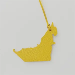 Yellow genuine leather bag charm detailed close-up showing fine texture and unique animal shape.