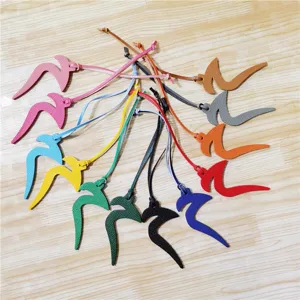 Colorful leather bag charm and car hanging accessory, detailed view of various colors.