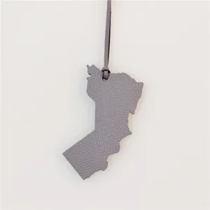 Grey leather map shaped bag charm, stylish premium keychain pendant accessory for handbags.