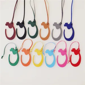 Colorful leather bag charm pendant accessory, stylish horseshoe design for handbags and purses.