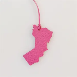 Pink leather map shaped bag charm detail closeup, stylish handbag pendant accessory decoration