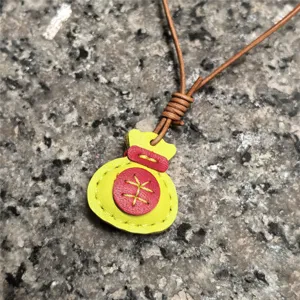 Handmade leather lucky bag pendant, cute colorful bag charm and stylish necklace accessory.