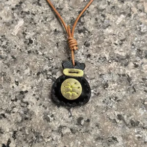 Closeup detail of the handmade genuine leather fortune bag pendant with classic design.