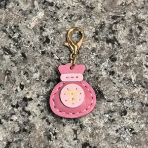 Llavero de bolsa de la suerte de cuero genuino hecho a mano, colgante rosa para bolso.