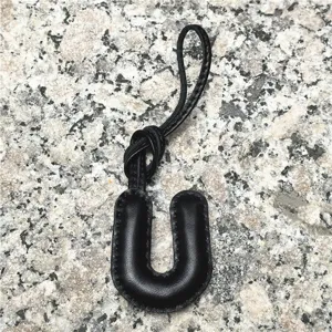 Black leather letter U bag charm alphabet initial pendant car accessory detail view