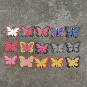 Vista detallada de mini dijes de bolso de mariposa de cuero, accesorios lindos.