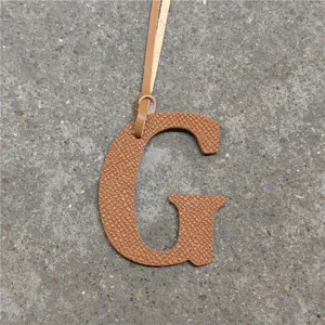 Brown leather letter G bag charm pendant stylish uppercase alphabet handbag ornament accessory.