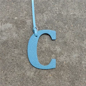 Blue leather letter C bag charm pendant accessory for women handbags and purses detail view.