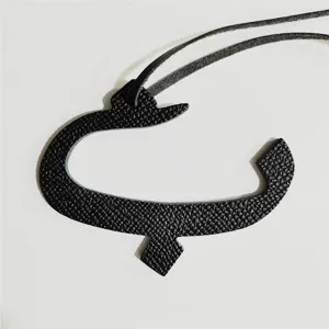 Black leather Arabic letter bag charm stylish pendant accessory for women handbags and daily wear.