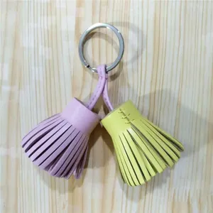 Detail view of the dual-color leather tassel keyring, showcasing the vibrant pink and yellow hues.