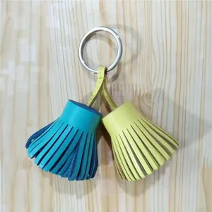 Close-up detail of the colorful leather tassel keychain and bag charm ornament pendant.