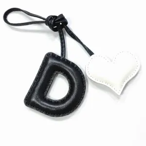 Handmade black leather letter D charm with white heart pendant for bags and car decor.