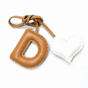 Handmade leather letter D and heart bag charm, brown and white contrast stitching pendant.