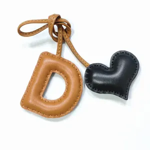 Handmade leather letter D and heart bag charm, stylish purse pendant and keychain accessory.