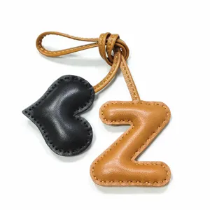 Leather letter Z and heart bag charm, handmade stitching detail, luxury style pendant accessory.