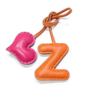 Handmade leather letter Z and heart bag charm with contrast stitching, stylish accessory.