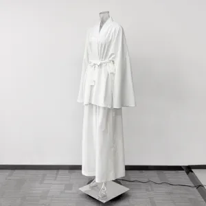 Detail view of casual white loungewear set featuring long sleeve kimono cardigan and pants.