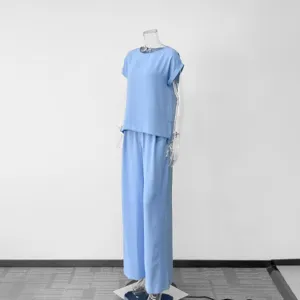 Light blue casual two-piece pants set for women, summer short sleeve top and wide-leg trousers.