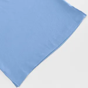 Light blue fabric detail of casual loose shirt, soft texture, simple and elegant daily wear.
