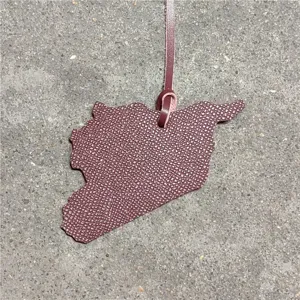 Detailed shot of Syria map shaped leather bag pendant car hanging ornament with pebbled texture.
