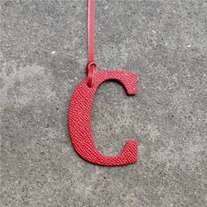 Red leather letter C bag charm initial pendant stylish accessory for women's handbags.