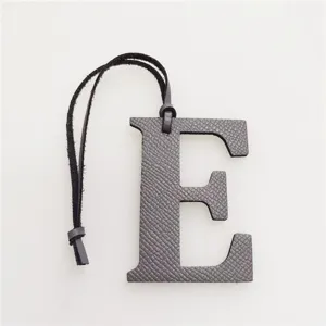Dark grey leather letter E bag charm accessory, stylish monogram keychain for purses and handbags.