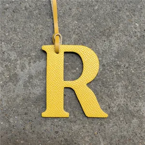 Yellow leather letter R bag charm accessory, stylish alphabet handbag pendant keychain.