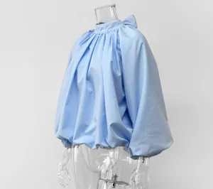 Light blue French style blouse featuring chic stand collar, bow tie and elegant bubble sleeves.