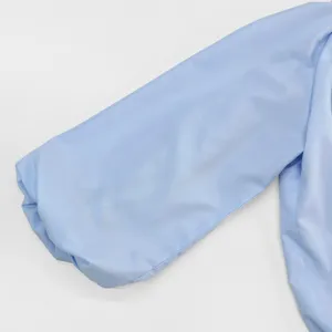 Close-up detail of a light blue puff sleeve on a solid shirt, smooth fabric texture.