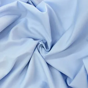 Light blue fabric material detail showing soft texture, smooth drape and elegant folds.