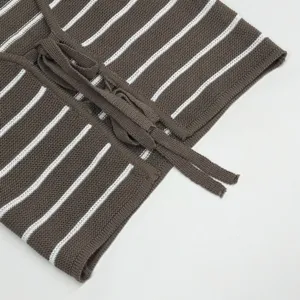 Close-up detail of striped knit top, showing texture and drawstring design, casual style.