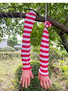 Halloween bloody severed hand hanging prop, scary red white striped sleeve outdoor decor detail.