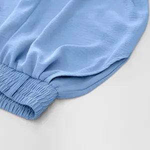 Light blue pleated women garment detail elastic waist casual wear fabric texture close up view