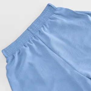 Detail view of light blue casual trousers elastic waistband, comfortable fit fabric.