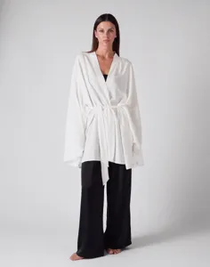 Details of the white tie cardigan and black trousers set, loose fit casual resort wear.